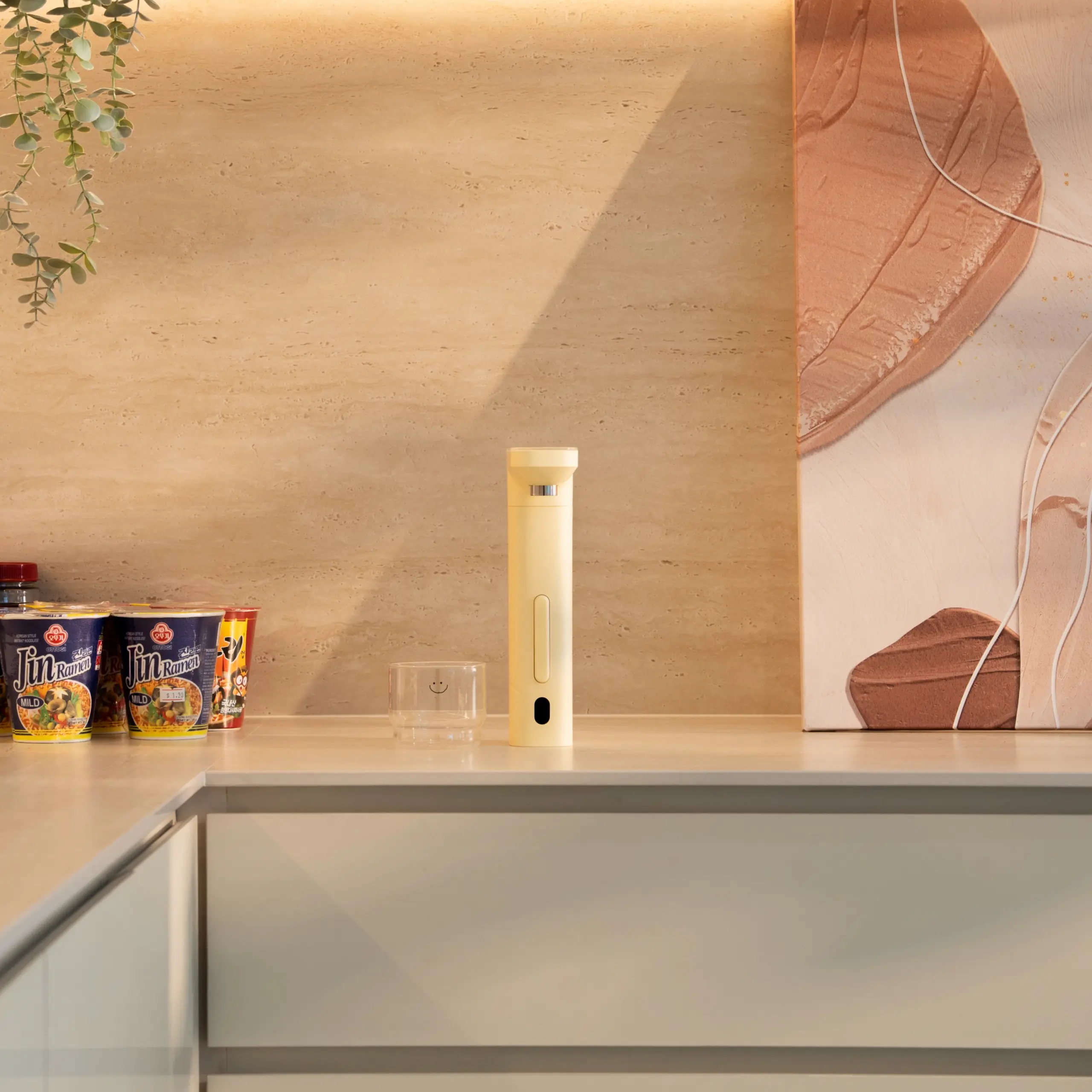 Happie dispenser placed on a kitchen countertop, showcasing its compact, minimalist design and easy access for daily use.