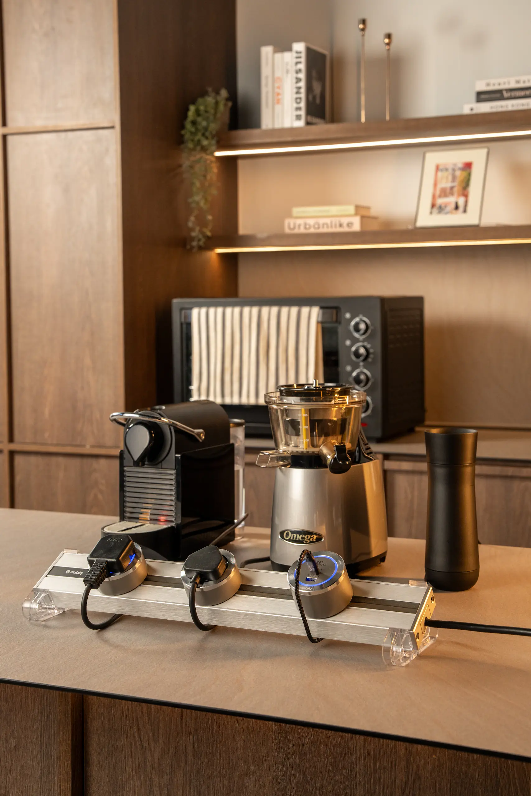 Eubiq track and adapter on a kitchen countertop, powering multiple appliances to demonstrate versatile home use.